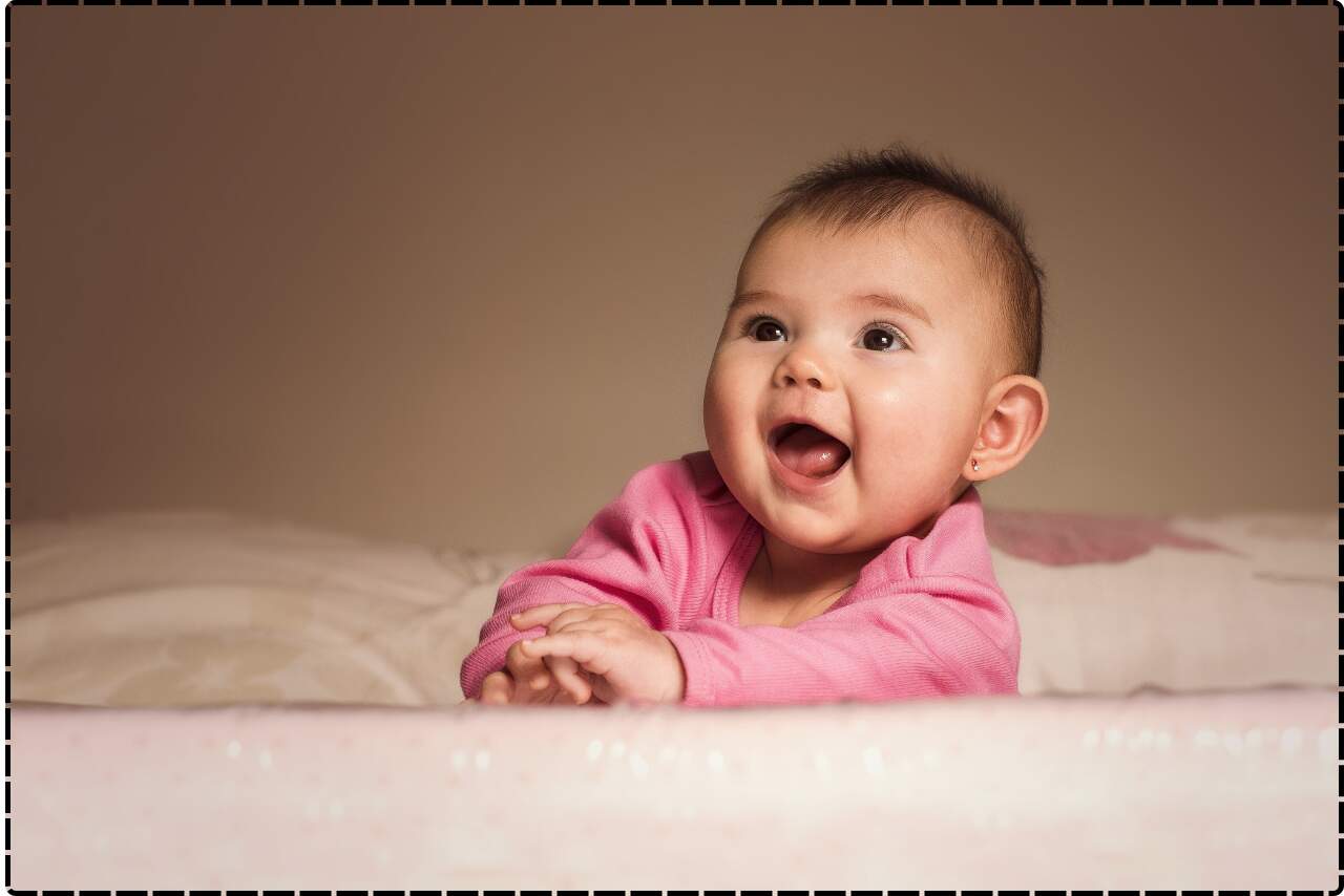 Joyful baby with a big, toothless smile, radiating happiness.